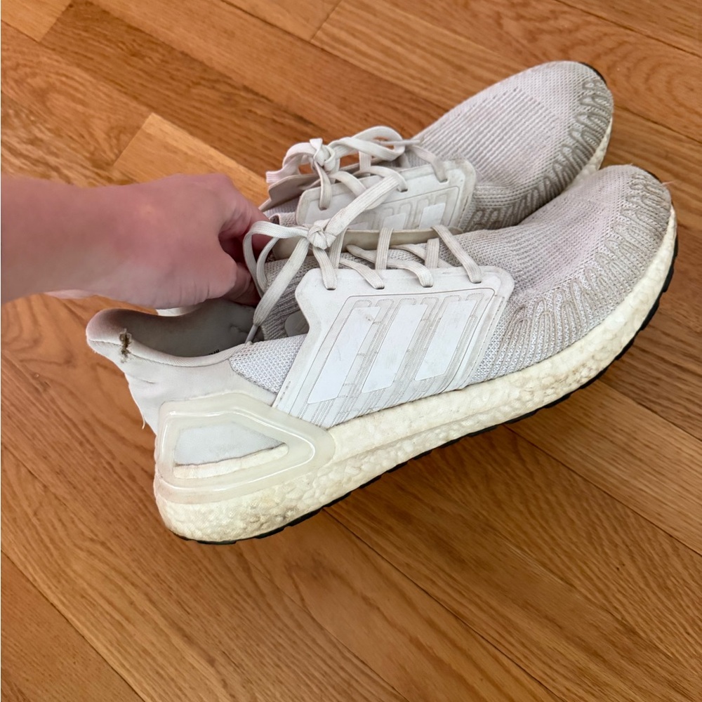 White Adidas NMDs sneakers